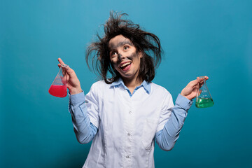Crazy chemist acting dumb while having glassware beakers filled with liquid substances. Silly...