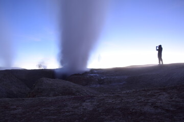 Fototapeta na wymiar A geyser shoots out of the ground, a photo at dawn on a long exposure., on Eduardo Avaroa National Reserve in Uyuni