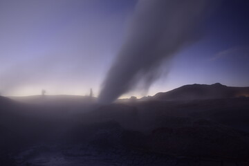 A geyser shoots out of the ground, a photo at dawn on a long exposure., on Eduardo Avaroa National Reserve in Uyuni