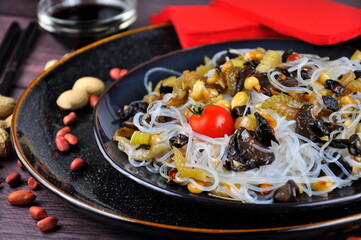 Chinese noodles with celery, peanuts and fried mushrooms.