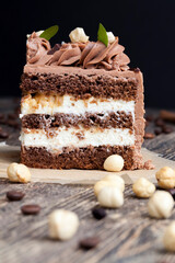 a piece of cake made of chocolate sponge cake cream and caramel with hazelnuts