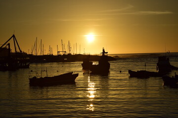 Fishing boats at the City pier at sunset on the harbor of Antofagasta, Chile.