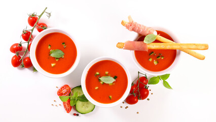 cold tomato gazpacho soup with basil isolated on white background