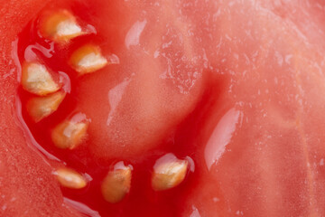 Macro photo of half cut tomato slice with seeds. Tomato slice texture.