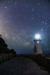 Naklejka na ściany i meble lighthouse at night in the sea