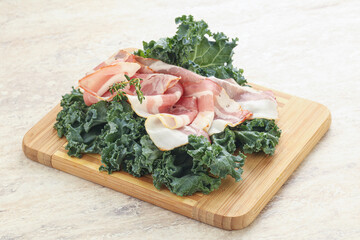 Raw pork bacon over board