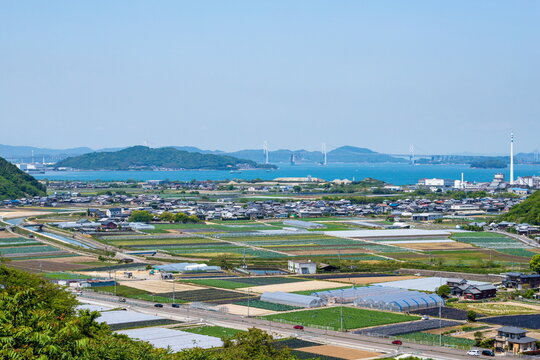 Landscape of sakaide city suburbs with the seto ohashi bridge , kagawa, shikoku, japan
