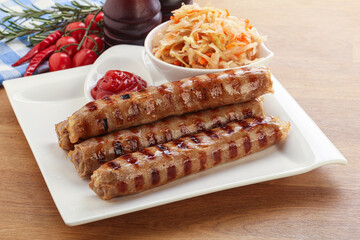 Grilled sausages with cabbage and sauce