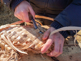 Weaving bast shoes by hand.