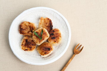 Wingko or Wingko Babat, a traditional Indonesian snack made from grated young coconut, glutinous rice flour, and sugar. Selected focus.
