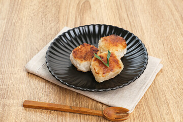 Wingko or Wingko Babat, a traditional Indonesian snack made from grated young coconut, glutinous rice flour, and sugar. Selected focus.
