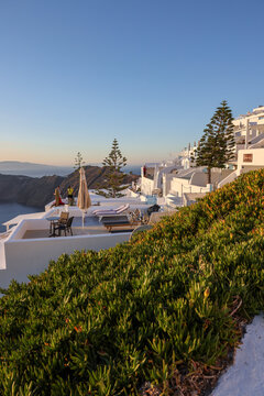 Imerovigli, Santorini, Greece - June 29, 2021: Whitewashed houses with terraces and pools and a beautiful view in Imerovigli on Santorini island, Greece