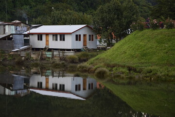 Fototapeta na wymiar Houses on stilts (palafitos) reflected in the water in Castro, Chiloe Island, Patagonia, Chile