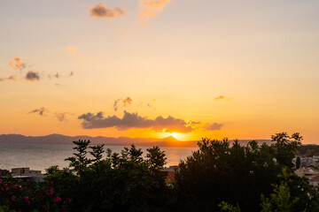Early morning sunrise over the sea . Some clouds.