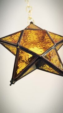 Festive gold star hangs in motion