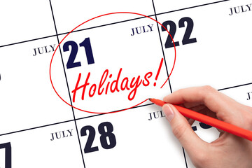 Hand drawing a red circle and writing the text Holidays on the calendar date 21July. Important date.