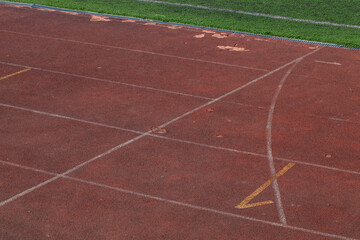 the red surface of the old running track at the stadium