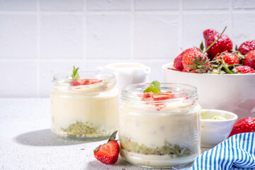 Sweet matcha strawberry dessert. Breakfast layered parfait dessert with yogurt, matcha green tea sponge biscuit and fresh strawberry, white background copy space