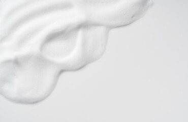 Skincare cleanser foam texture. Copy space and soap bubbles on white background. - obrazy, fototapety, plakaty