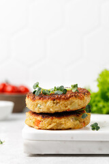 Vegan burgers cutlets with quinoa, vegetables, microgreens on marble board. Healthy food concept. Copy space
