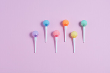 Close up of  colorfull lollipops on a pink backround. Minimalistic flat lay, top view, copy space.
