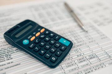 Pen and calculator on desk office. Object for calculator to calculate balance, projit, currency and cost. Accounting and  Financial concept.