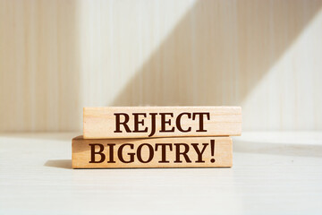 Wooden blocks with words 'Reject Bigotry'. - obrazy, fototapety, plakaty