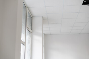 Fototapeta premium White ceiling in the office. White ceiling can reflect light well. The right light at work. Abstract empty white interior space office. copy space.