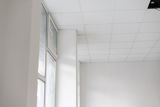 White ceiling in the office. White ceiling can reflect light well. The right light at work. Abstract empty white interior space office. copy space.