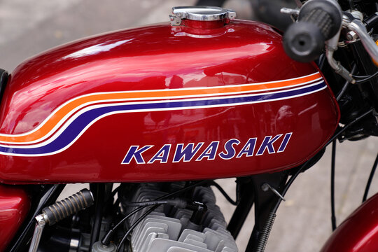 Kawasaki logo brand and text sign on old motorcycle vintage red petrol retro tank fuel