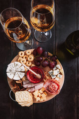 Wine appetizer, charcuterie and cheese platter flat lay, top view on wooden background