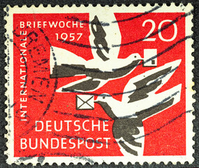 GERMANY - CIRCA 1957: A postage stamp from Germany Saar, showing a two pigeons with a letter in...