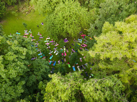 Overhead View Of People Do Yoga At City Public Park