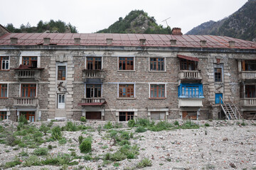 Old abandoned building with ruined balconies and crashed windows . Abandoned mining village , North Ossetia-Alania , Sadon , Russia