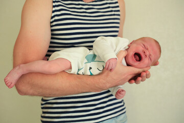 Little boy crying in dad's arms. Selective focus