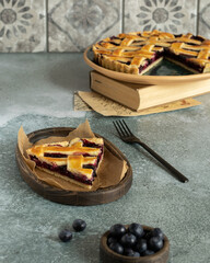 Blueberry pie decorated with a lattice of dough. Berry cake. Piece of blueberry tart. Shortcrust...
