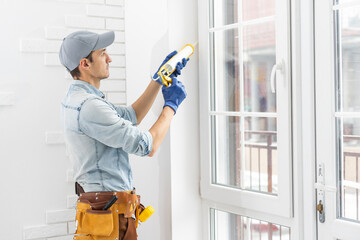 worker installing new plastic pvc window