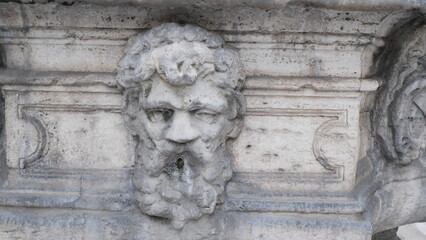 Ancient Roman fountain in the shape of a head