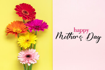 Bouquet of gerberas, text Happy Mother's Day on yellow, pink background Top view Flat lay Holiday greeting card
