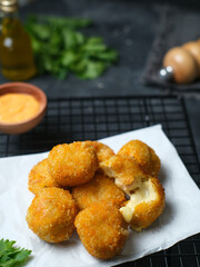 Delicious homemade bitterballen made from flour, cheese, milk coated with bread crumb filled with mozzarella. Selective focus image.