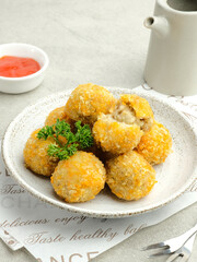 Delicious homemade bitterballen made from flour, cheese, milk coated with bread crumb filled with mozzarella. Selective focus image.