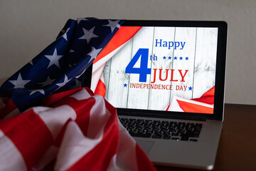 Fototapeta na wymiar laptop with Inscription Happy independence day on usa flag.