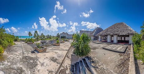 Picture of a destroyed, overgrown and left to itself hotel complex on a beach