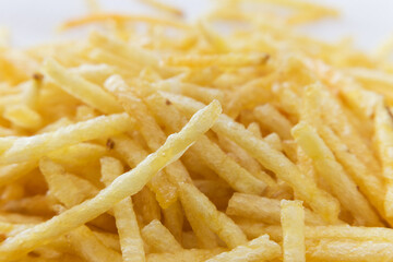 Straw potatoes stacked on white background