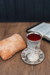 Christian communion, bread and wine on wooden background