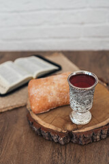 Christian communion, bread and wine on wooden background