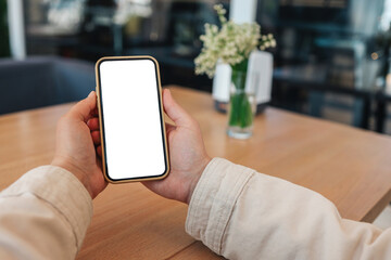 Close-up of a phone with a screen in hands in a cafe on the street