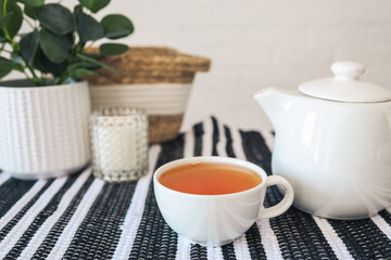 Cup of tea on the table, cozy interior photo in the kitchen