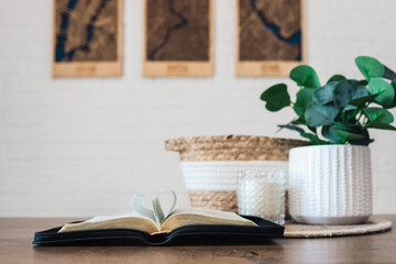 Open Bible with heart-shaped pages on a table with beautiful decor, morning reading of the Word, God is love