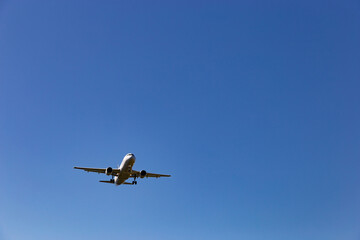Airplane flying in the blue sky.